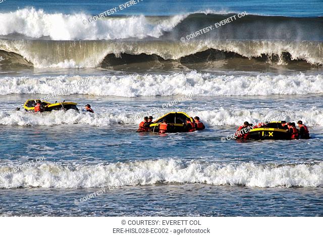 US military personnel in six-month SEAL training Underwater Demolition course in a surf passage exercise. Oct. 27 2010. BSLOC-2011-12-268