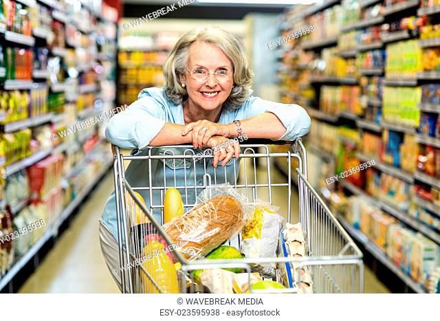 Smiling senior woman with cart