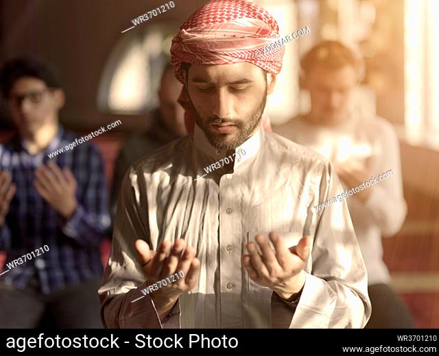 group of muslim people praying namaz in mosque