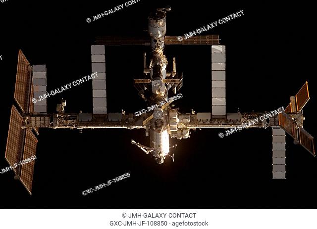 The International Space Station is featured in this image photographed by a STS-120 crewmember as Space Shuttle Discovery approaches the station during...