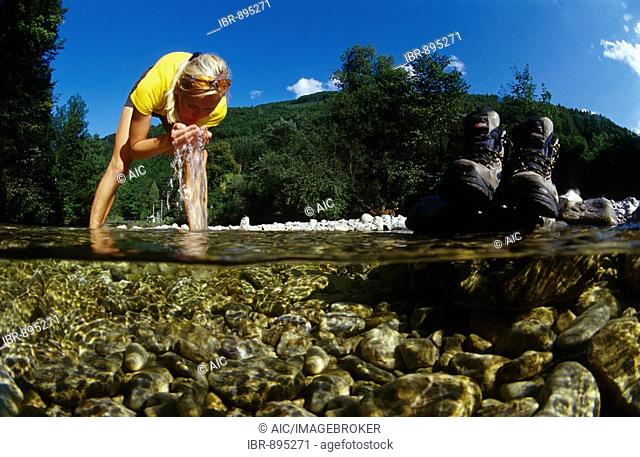 Woman, 22, refreshing herself while standing in a mountain stream, Kalkalpen National Park, Upper Austria, Austria, Europe