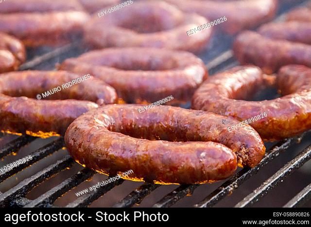 Close up view of many portuguese chorizos on a barbecue