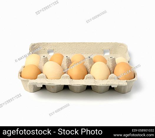 fresh whole brown eggs in paper packaging isolated on white background