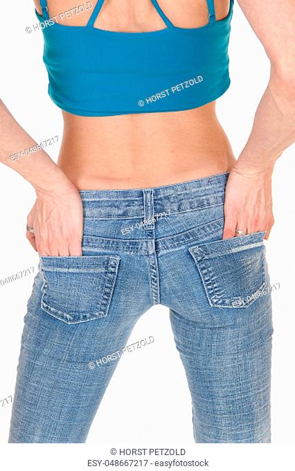 A young slim woman standing in jeans with her hands in her pocket.from the back, body part, isolated for white background