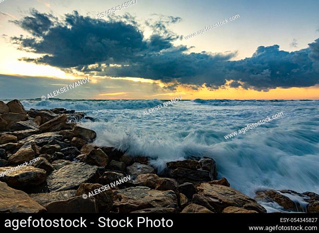 Seascape on rocky shore in storm