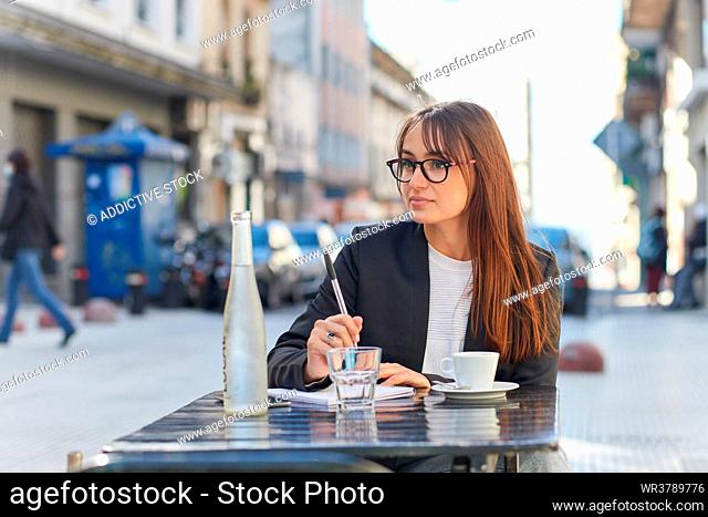 business woman, pensive, cafe, note pad