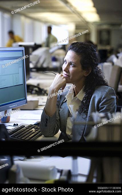 Caucasian businesswoman daydreaming at desk