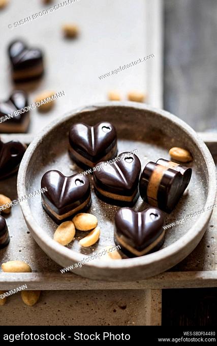 Bowl of heart shaped pralines with peanuts