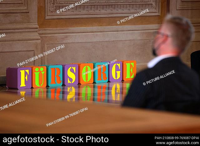 08 August 2021, Bavaria, Augsburg: The word ""care"", made up of cubes, is displayed in the golden hall of the town hall as part of the Peace Festival