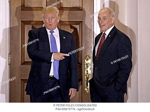 United States President-elect Donald Trump (L) gestures with retired US Marine Corp General John Kelly at the clubhouse of Trump International Golf Club