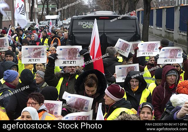 07 March 2023, Berlin: Participants in the warning strike of the public service union Verdi protest during a rally in front of the headquarters of Berlin's...