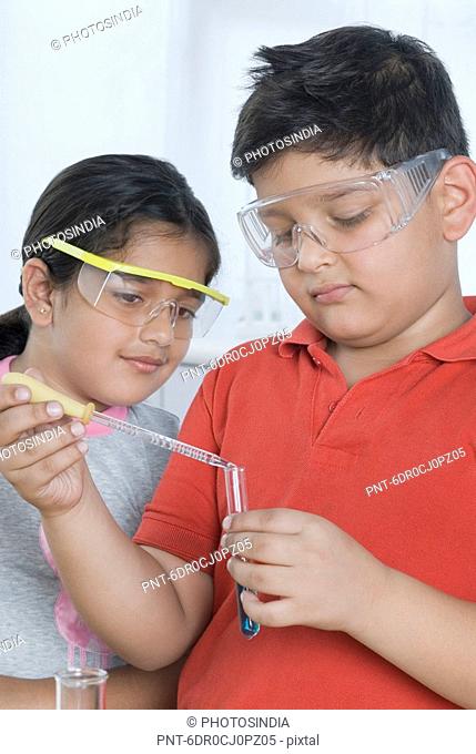 Boy and a girl doing scientific experiment in a laboratory