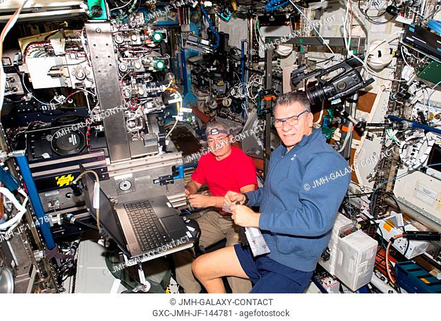 Astronauts Mark Vande Hei (left) and Paolo Nespoli work on the Combustion Integrated Rack (CIR) inside the Destiny laboratory module