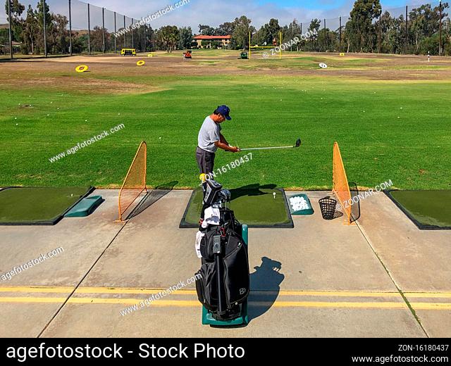 Golfer practicing at golf driving range practice facility, San Juan, California, USA, October 3rd, 2020