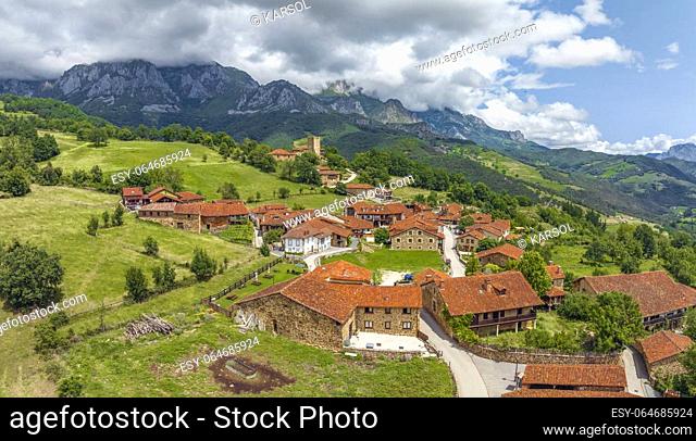 Mogrovejo village overlooking Peaks of Europe mountains with wooden balcony, Cantabria, Spain. named beautiful town of Spain