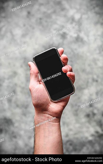 Smart cell phone with black screen in hand