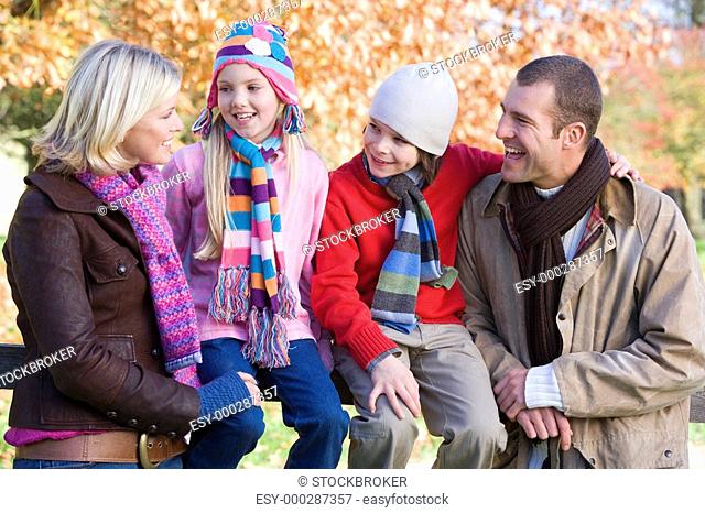 Family outdoors in park smiling selective focus