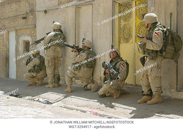 IRAQ Samarra -- 18 Aug 2004 -- US Army soldiers remain alert as they clear alleyways in Sadr City, Iraq. The 5th Cavalry Regiment is supporting 'Operation Iron...
