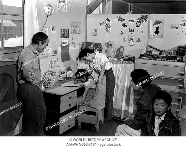 Photographic print of Tojo Miatake and family at the Manzanar Relocation Centre, California. Photographed by Ansel Adams (1092-1984). Dated 1943