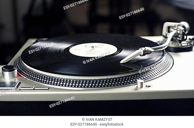 DJ mixer with a vinyl record, close up