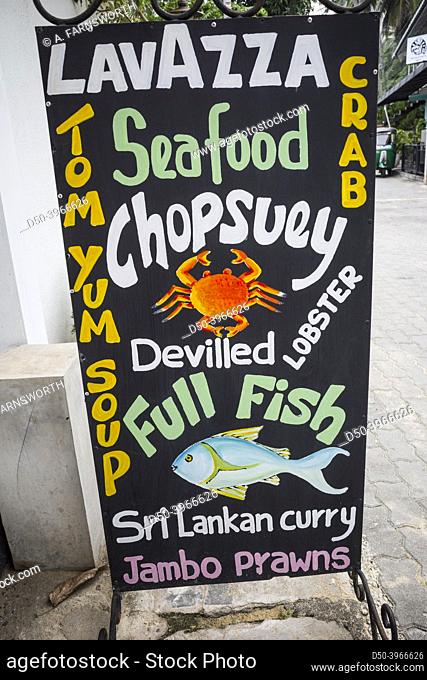 Unawatuna, Sri Lanka A vibrant restaurant sign selling prawns, fish, seafood, lobster and crab