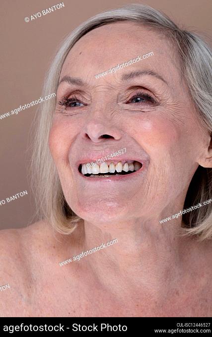 Studio portrait of smiling senior woman