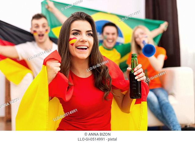 Beautiful spanish girl with her friends cheering football match. Debica, Poland