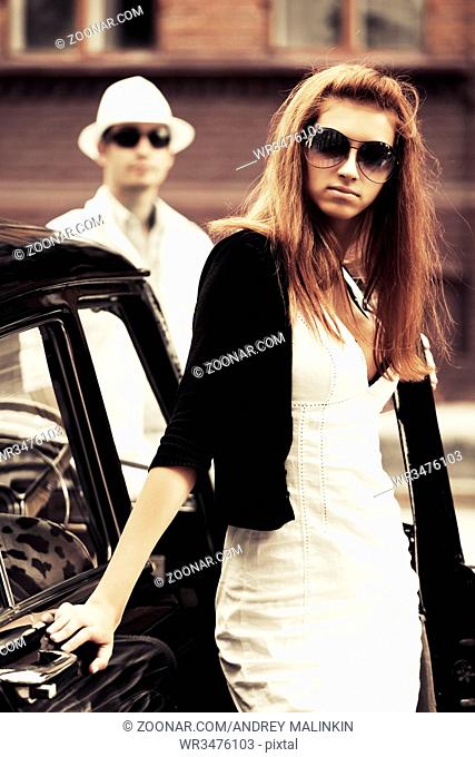 Young fashion couple by retro car