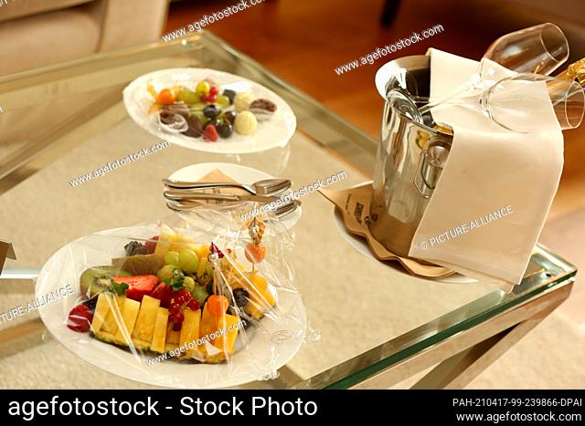 16 April 2021, Saxony-Anhalt, Stolberg: Employees prepare a small welcome snack in the room at the Hotel Naturressort Schindelbruch