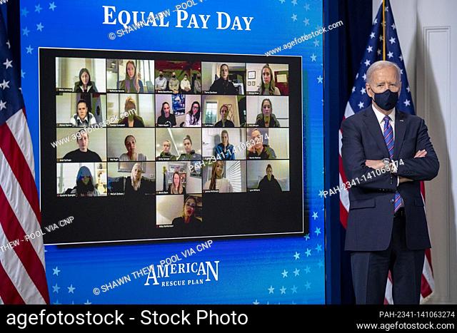 US President Joe Biden listens as First Lady Dr. Jill Biden delivers remarks during an event to mark Equal Pay Day in the State Dining Room of the White House...