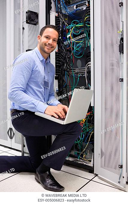 Man doing maintenance at the data store with laptop