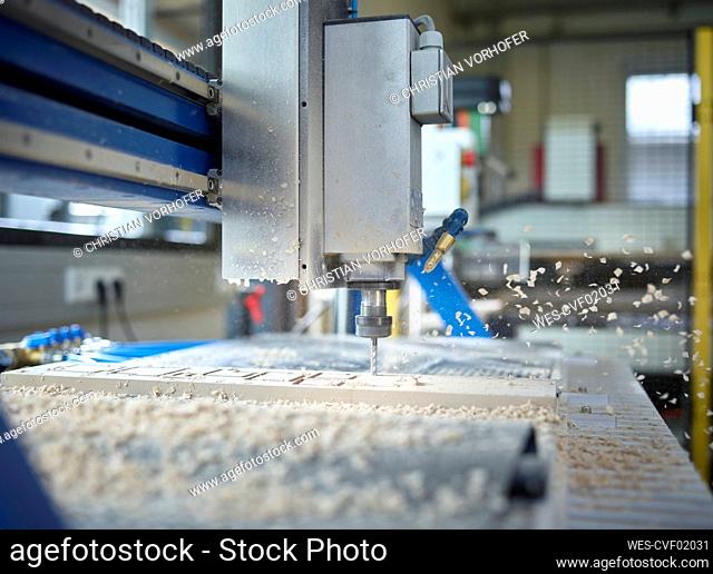 CNC machine cutting wood in factory