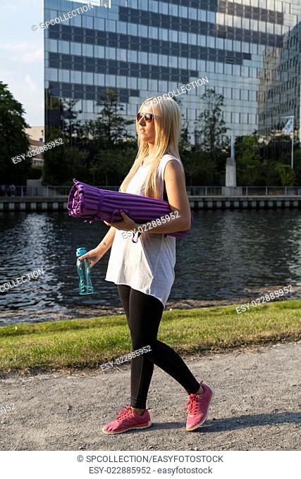 Woman in sportswear with camping mat