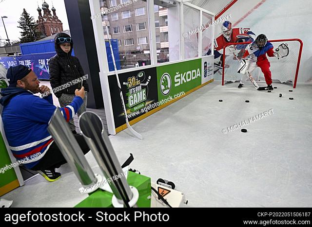 A Czech fan shortens his wait for the game on the goalie trainer in the fanzone, prior to the 2022 IIHF Ice Hockey World Championship