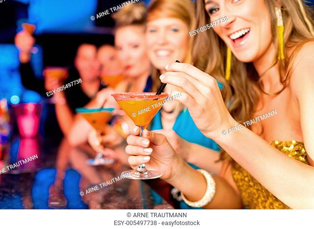 Leute in einem Club oder einer Bar trinken Cocktails