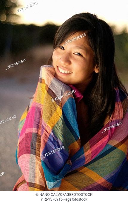 Cute young asian woman at sunset