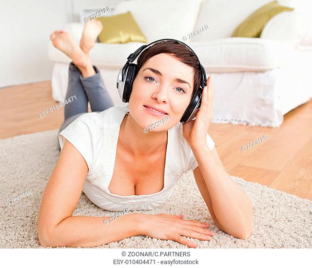 Close up of a smiling brunette listening to music