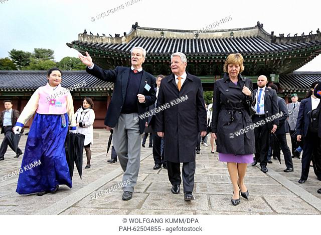 University professor Hans Alexander Kneider (2nd L) guides German President Joachim Gauck (3rd L) and his partner Daniela Schadt (R) through Changdeokgung...