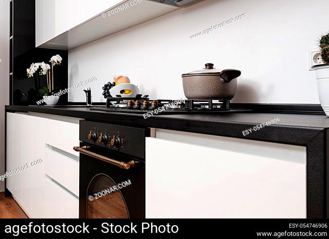 Closeup of modern black and white kitchen made in classic style