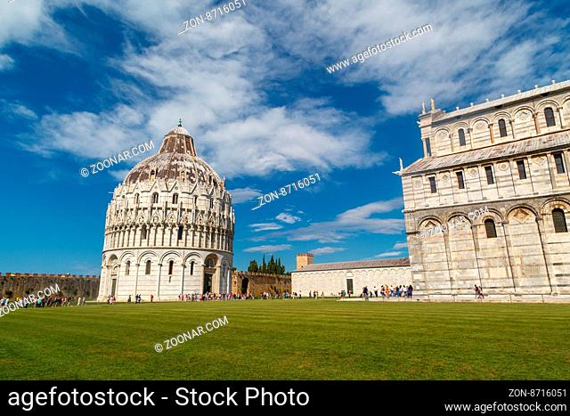 PISA , ITALY - SEPTEMBER 21, 2015 : View of historical old Pisa Cathedral in Cathedral Square in Pisa, Italy, on cloudy blue sky background