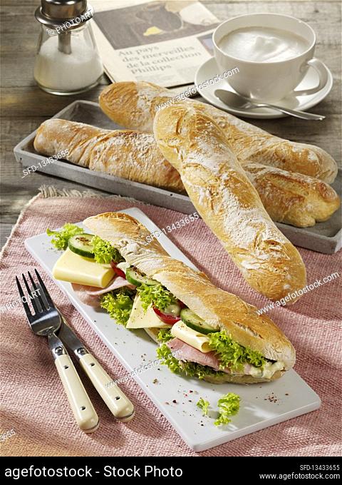French FlÃ»te bread topped with ham, cheese and salad