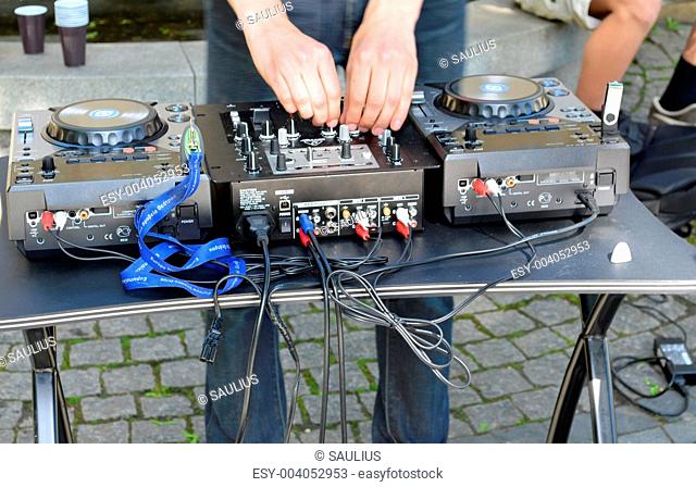 Dj hands play mix track turntable panel in street