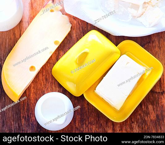 milk products on the wooden table, cottage and butter