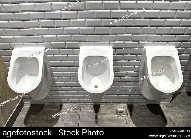 Many urinals in a toilet