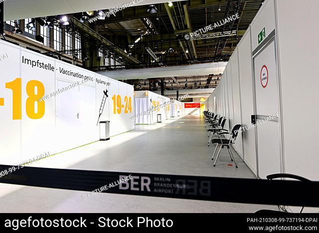 08 March 2021, Berlin: Chairs stand in front of vaccination booths at the new Corona Vaccination Center at the former Tempelhof Airport shortly before its...