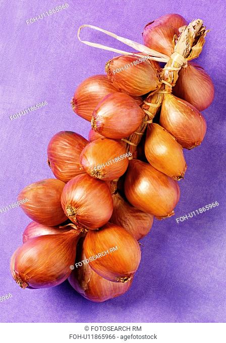 String Of Shallot Onions On Purple