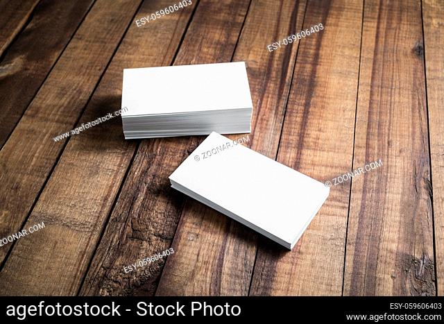 Photo of blank business cards on a wooden background. Template for ID. Top view
