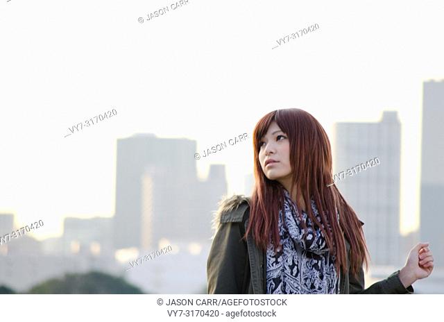 Japanese Girl poses on the street in Odaiba, Japan. Odaiba is a area by the sea in Tokyo