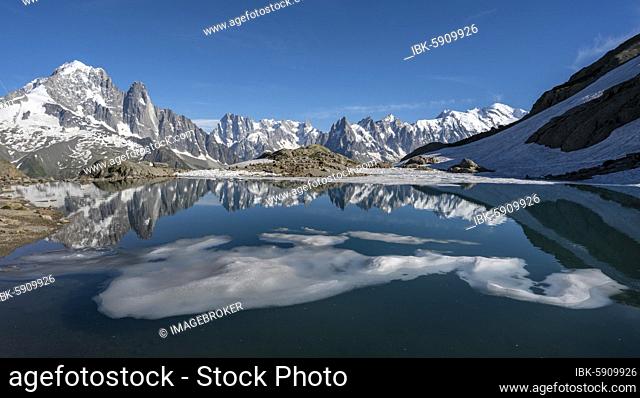 Mountain panorama, ice floe on Lac Blanc, mountain peaks reflected in mountain lake, Grandes Jorasses and Mont Blanc massif, Chamonix-Mont-Blanc, Haute-Savoie