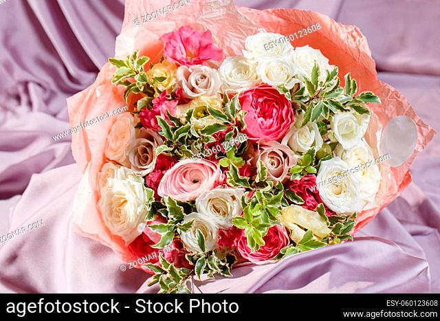 beautiful bouquet made of different flowers. colorful color mix flower on a table covered with a cloth